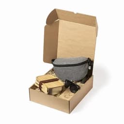 A gift box contains a grey bag, wooden containers, and sunglasses, all nestled in shredded paper.