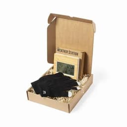 A weather station and black gloves in a cardboard box, with straw filling for presentation.