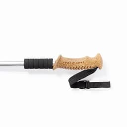 A trekking pole with a cork grip, rubberised sections, and an adjustable wrist strap, featuring a silver shaft.