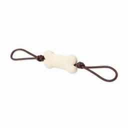 A chew toy shaped like a bone, featuring a brown rope on either end. The toy is in a cream colour.