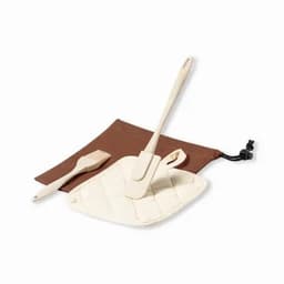 A cooking utensil set featuring a beige spatula and brush, accompanied by a brown carrying pouch.