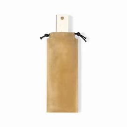 A drink bottle in a golden fabric pouch with a drawstring closure. The pouch has a subtle texture.