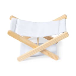 A folding chair with a wooden frame and white fabric seat and backrest. It features an X-shaped design.