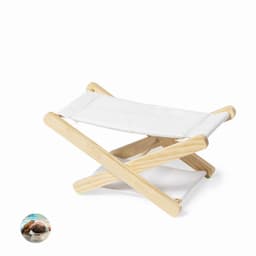 A folding stool with a wooden frame and white fabric seat, featuring a simple, minimalist design.