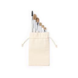 A set of makeup brushes in a cream-coloured drawstring pouch, featuring various brush sizes and shapes.