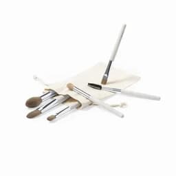 A brush set with various makeup brushes in a cream-coloured fabric pouch. The brushes feature silver handles.