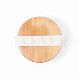 A round wooden disc with a cream-coloured fabric strap attached. It features a smooth surface and natural wood grain.