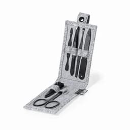 A grooming kit featuring various tools in a grey felt case, including scissors and a nail file, with a logo.