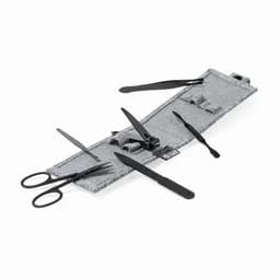 A grey tool roll containing various black manicure instruments, including scissors, files, and cuticle pushers.