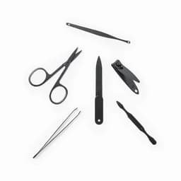A set of six black grooming tools, including scissors, tweezers, and a nail file, arranged in an appealing layout.