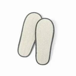 A pair of white slippers with a herringbone pattern and grey trim. The slippers are flat and comfortable in design.