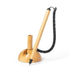 A bamboo pen holder with a black pen attached by a coil. The base is round and features a natural wood finish.
