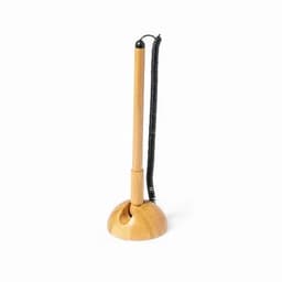 A wooden pen holder with a coiled wire and a slender pen standing upright. The base is rounded and smooth.