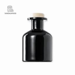 A drink bottle in a sleek black design with a cream-coloured cap. It features a logo on the side.