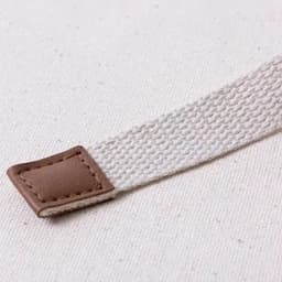 A textured strap in light cream colour, featuring a brown leather accent at one end.