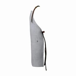 A grey apron with a pocket and a brown leather strap. It has a simple design and a classic colour scheme.