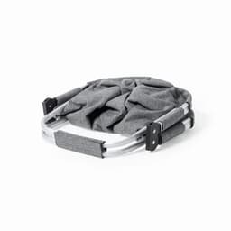 A portable grey camper chair with a foldable metal frame, featuring padded handles for comfort.