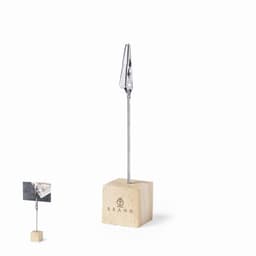 A photo holder with a wooden base and a metal clip, designed for displaying photos or notes.