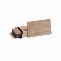 A set of wooden coasters stacked in a box, featuring a natural brown finish. The box is partially open.
