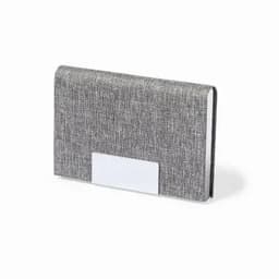 A grey textured notebook with a plain white label on the front, featuring a sleek design.