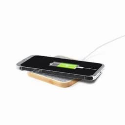 A wireless charger with a wooden base and a phone placed on it, displaying a charging battery icon.