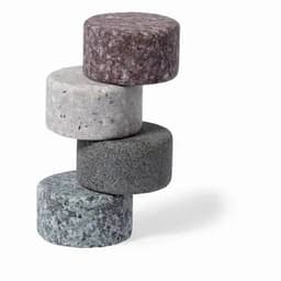 A stack of four round stones in shades of grey, black, and brown, with a smooth texture and varying patterns.