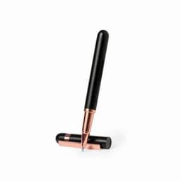 A pen with a black body and rose gold accents, positioned upright with its cap on the base.