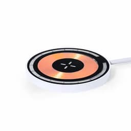 A wireless charger with a circular design, featuring a white exterior and a copper-coloured charging surface.