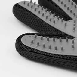 Black gloves with textured grey palms featuring raised grip points, designed for enhanced traction.