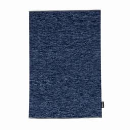 A blue textured towel with a woven pattern and a small tag at the bottom edge.