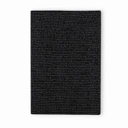 A black textured notebook with a woven pattern and a simple, minimalist design. It features a logo on the cover.