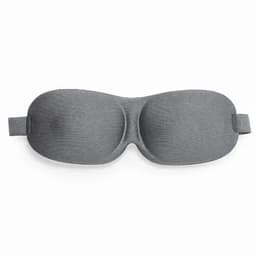 A sleep mask in a smooth grey fabric with a contoured design for comfort. It features an adjustable strap.