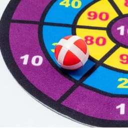 A dartboard with colourful sections and a red and white dart resting in the purple area marked '10'.