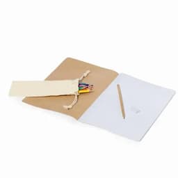 A notebook with a kraft cover, featuring a pouch of coloured pencils and a wooden pencil inside.