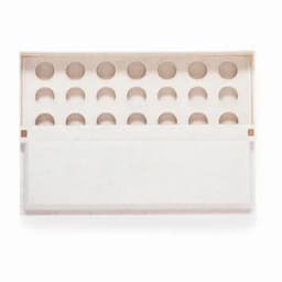 A white product packaging box with multiple circular compartments for holding items, featuring a lid that opens.