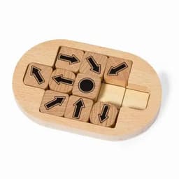 A wooden puzzle featuring arrow-shaped blocks in black and natural wood, arranged in an oval tray.