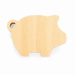 A wooden pig-shaped cutting board in a natural light colour with a small hole for hanging.