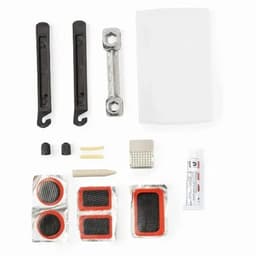 A bike repair kit featuring black levers, a multi-tool, patches, glue, and a carrying case.