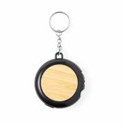 A keychain featuring a round black casing with a wooden circular insert. It includes a metal loop for attachment.