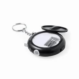 A keychain tool with a black casing, featuring compartments for small bits and a ring for attachment.