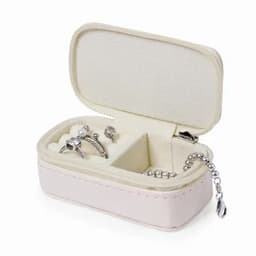 A jewellery box in soft pink with compartments, holding silver rings and a chain. It features a zip closure.