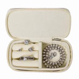 A jewellery case containing a bracelet, two rings, and a pair of earrings, all in silver tones.