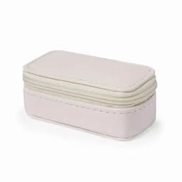 A storage box in soft pink, featuring a textured exterior and zip closure. It has a subtle stitching detail.