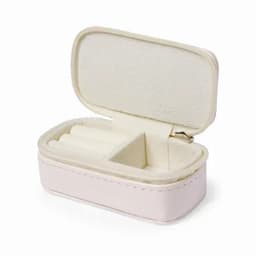 A small, soft leather jewellery case in pale pink with a zipped closure and plush interior.