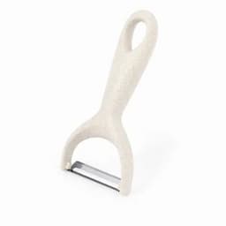 A potato peeler with a light beige handle and a stainless steel blade, featuring a simple, ergonomic design.