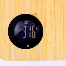 A bamboo kitchen scale with a digital display showing the weight as 316. The scale features a round black interface.