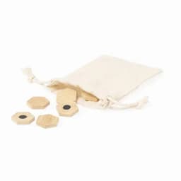 A drawstring bag in cream contains five wooden hexagonal pieces, each featuring a black dot.