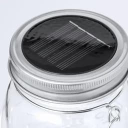 A drink bottle with a clear glass body and a silver metal lid featuring a solar panel on top.