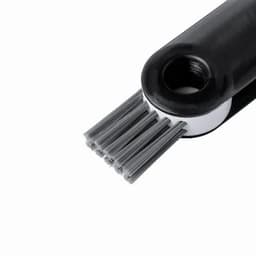 A cleaning brush with a black handle and grey bristles, featuring a round hole at the end. It has a logo on the handle.
