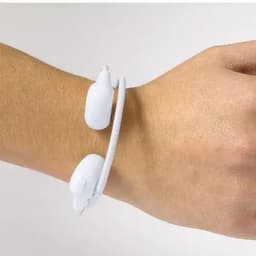 A white fitness tracker with two buttons, worn on a wrist. The tracker has a simple design and flexible band.